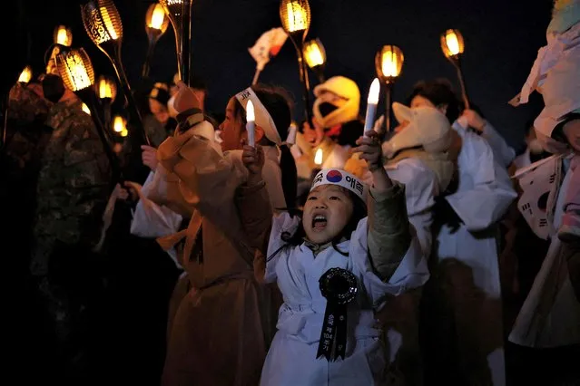 Participants carrying torches march during a re-enactment of the March First Independence Movement against Japanese colonial rule in Cheonan, South Korea on February 28, 2023. (Photo by Kim Hong-Ji/Reuters)