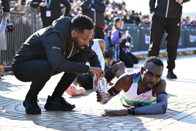 Ethiopia’s Addisu Gobena – who took second place in the men’s race – accepts a drink after crossing the finish line during the 2025 Sydney Marathon on August 31, 2025 in Sydney, Australia.. (Photo by Bianca de Marchi/AAP)