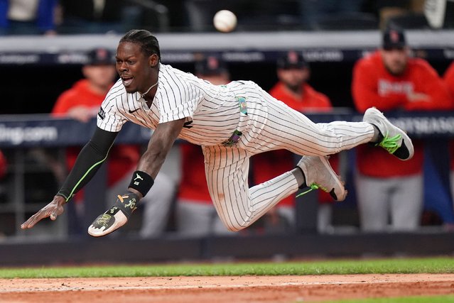 New York Yankees Jazz Chisholm Jr. dives into home plate to score on a hit by Austin Wells against the Boston Red Sox during the eighth inning of Game 2 of an American League wild-card baseball playoff series, Wednesday, October 1, 2025, in New York. (Photo by Frank Franklin II/AP Photo)