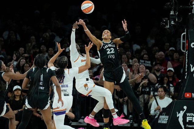 Las Vegas Aces center A'ja Wilson (22) and Phoenix Mercury guard Kahleah Copper battle for the ball during the second half in Game 1 of the WNBA basketball finals, Friday, October 3, 2025, in Las Vegas. (Photo by John Locher/AP Photo)