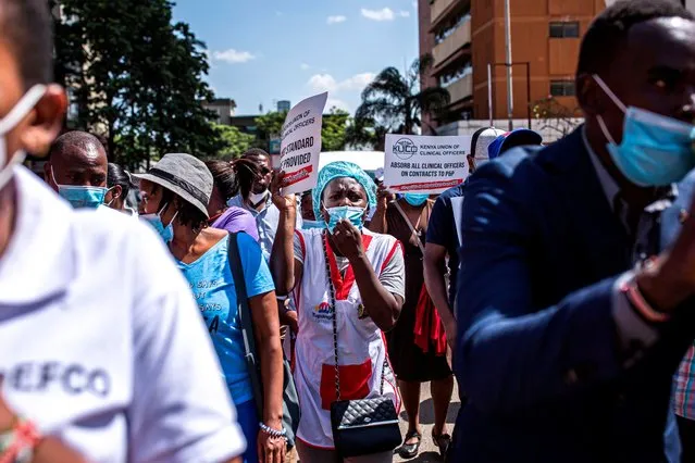 A nurse shouts during a protest organized by Nurses and Clinical Officers in Nairobi on December 14, 2020. Nurses and Clinical Officers went on strike on December 07, 2020 demanding safer working conditions after more than 60 health workers died of COVID-19 coronavirus since the beginning on the pandemic. (Photo by Patrick Meinhardt/AFP Photo)