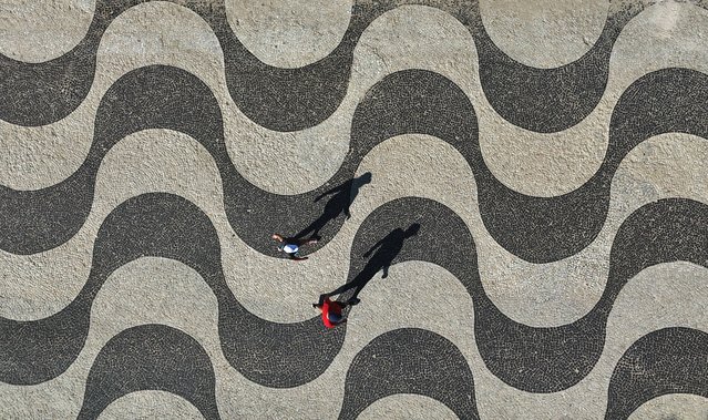A drone view shows people walking along the Leme beach in Rio de Janeiro, Brazil, on June 4, 2025. (Photo by Pilar Olivares/Reuters)