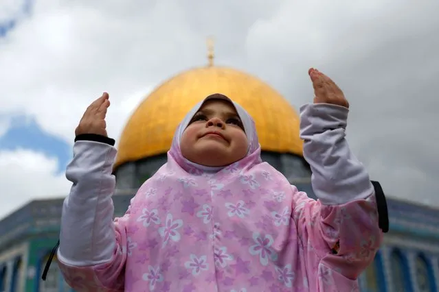 A child prays as Palestinian Muslims attend Friday prayers of the Muslim holy month of Ramadan, on the compound known to Muslims as the Noble Sanctuary and to Jews as the Temple Mount, in Jerusalem's Old City on March 31, 2023. (Photo by Ammar Awad/Reuters)