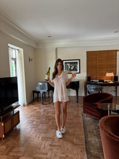 American model Emily Ratajkowski lounges in sheer while sipping champagne in the last decade of October 2025. (Photo by emrata/Instagram)
