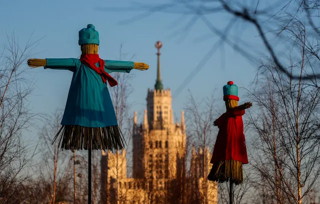 Effigies of Lady Maslenitsa are seen with a Stalin’s era skyscraper in the background during celebrations of Maslenitsa, also known as Pancake Week, a pagan holiday marking the end of winter, in central Moscow, Russia on February 25, 2020. (Photo by Maxim Shemetov/Reuters)
