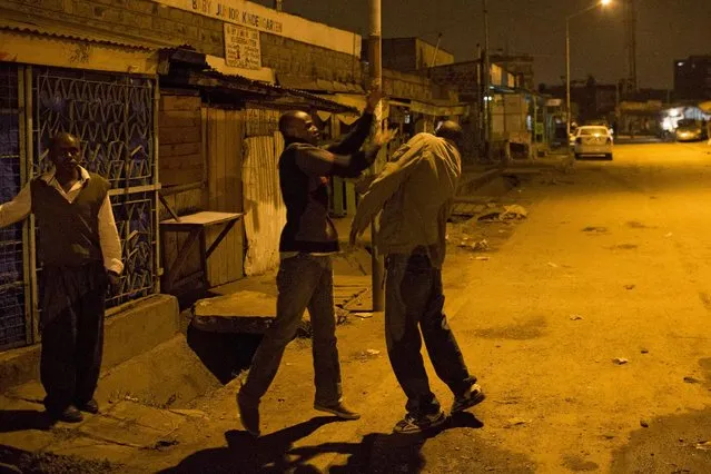 Two men pretend to fight outside a local bar in the Kariobangi neighbourhood in Nairobi, Kenya, June 14, 2015. (Photo by Siegfried Modola/Reuters)