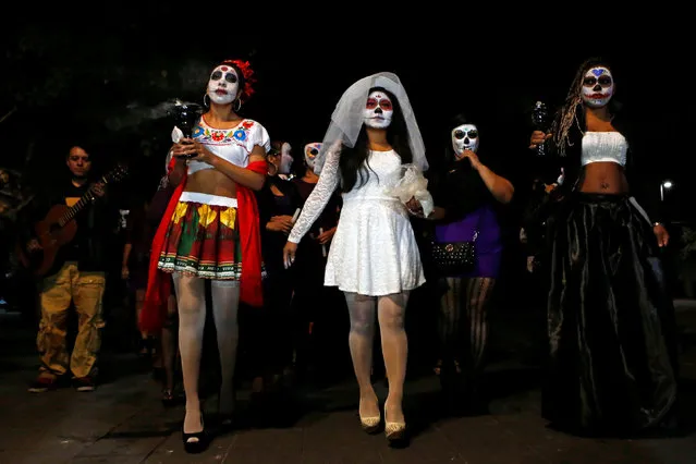 People walk in a procession organized by s*x workers to remember their deceased colleagues, especially those who were violently murdered, as part of the celebrations ahead of the Day of the Dead, in Mexico City, Mexico October 28, 2016. (Photo by Ginnette Riquelme/Reuters)
