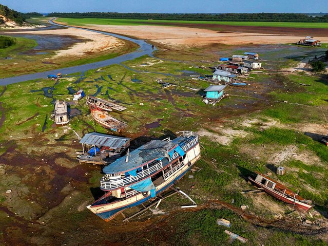 Boats are seen stranded in Aleixo Lake due to the severe drought in the west of Manaus, Amazonas State, Brazil, on September 20, 2024. (Photo by Michael Dantas/AFP Photo)