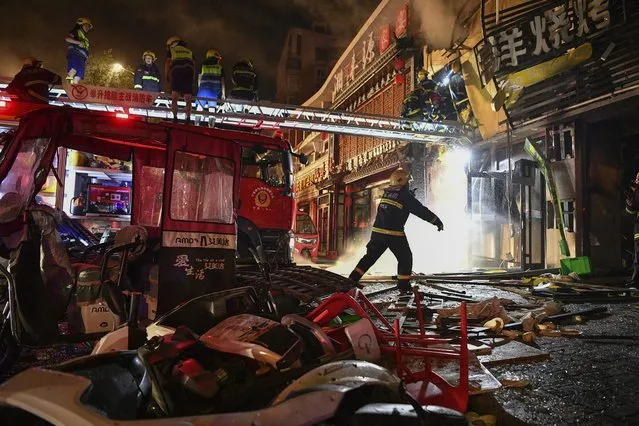 In this photo released by Xinhua News Agency, firefighters work at the site of an explosion at a restaurant in Yinchuan, northwest China's Ningxia Hui Autonomous Region, Wednesday, June 21, 2023. (Photo by Wang Peng/Xinhua via AP Photo)