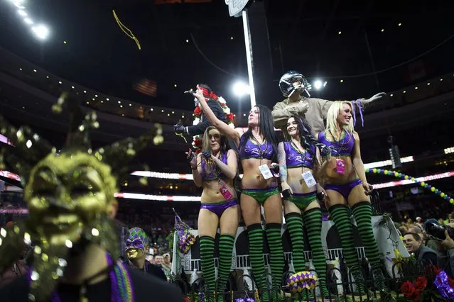 Cheerleaders supporting contestants throw beads to the crowd while parading through the Wells Fargo Center before the 23rd annual Wing Bowl in Philadelphia, Pennsylvania January 30, 2015. (Photo by Mark Makela/Reuters)