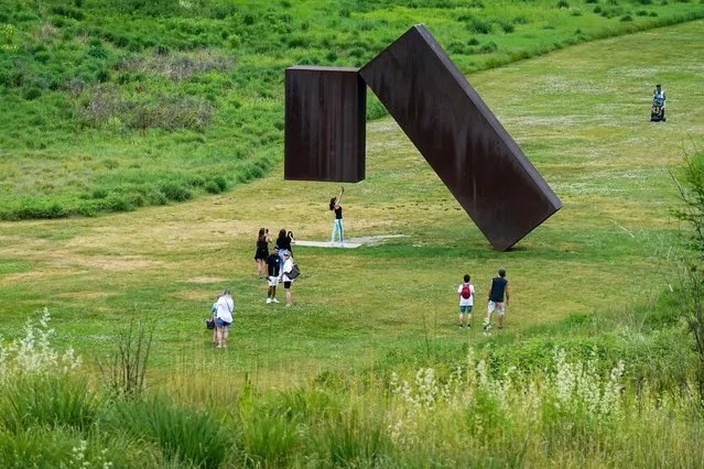 Visitors interact with Menashe Kadishman’s artwork “Suspended, 1977”, at the Storm King Art Center in New Windsor, New York, U.S., June 10, 2023. (Photo by Amr Alfiky/Reuters)