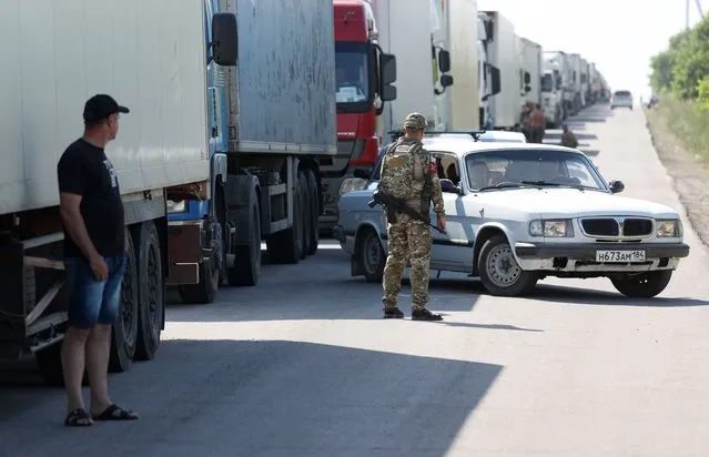 Pedestrians and vehicles queue to pass the Armyansk checkpoint between the Kherson Region and Crimea in Kherson Region, Russia on June 23, 2023. Early on June 22, acting Kherson Region Governor Saldo said Ukraine's Storm Shadow cruise missiles had hit bridges near the border village of Chongar. Vehicle traffic has been diverted to the alternative Armyansk and Perekop checkpoints. (Photo by Alexei Konovalov/TASS)