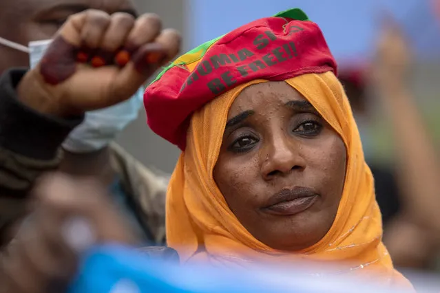 A member of Oromia community raises her fist during a protest against the conflict in the Ethiopia's Tigray region, outside the European Union offices in Pretoria, South Africa, Thursday, March 25, 2021. (Photo by Themba Hadebe/AP Photo)