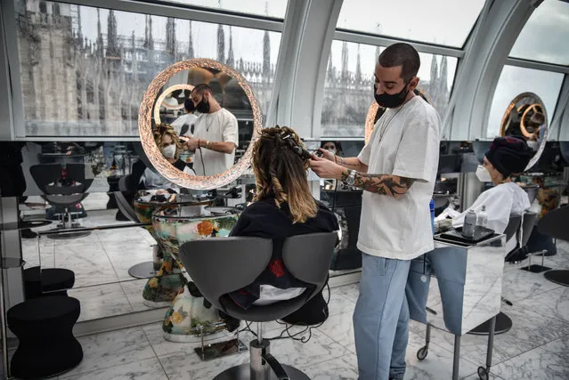 A hairdressing shop in the center of Milan, Italy, 12 April 2021. After the transition of Lombardy to the orange zone, a lower level of Co​vid-19 restrictions, many businesses have reopened. (Photo by Matteo Corner/EPA/EFE)
