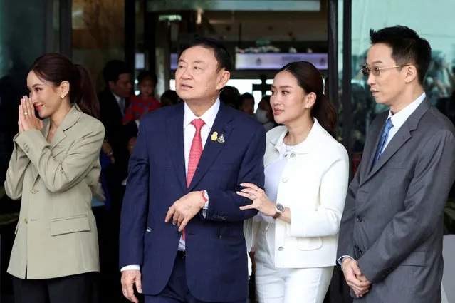 Former Thai Prime Minister Thaksin Shinawatra, who is expected to be arrested upon his return as he ends almost two decades of self-imposed exile, walks with his son Panthongtae Shinawatra and daughters Paetongtarn Shinawatra and Pintongtha Kunakornwong at Don Mueang airport in Bangkok, Thailand on August 22, 2023. (Photo by Athit Perawongmetha/Reuters)