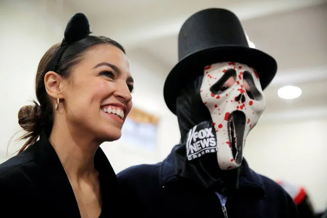 Democratic Congressional candidate Alexandria Ocasio-Cortez poses with an attendee as she attends the “Halloween with Alexandria” event at St Paul's Evangelical Lutheran Church in the Bronx, New York, U.S., October 31, 2018. (Photo by Andrew Kelly/Reuters)