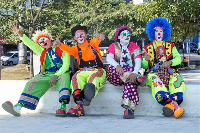 Salvadoran clowns participate in a parade within the framework of the National Salvadoran Clown Day that is celebrated on the first Wednesday of every December by legislative decree in San Salvador, El Salvador on December 07, 2022. After the pandemic crisis, dozens of Salvadoran clowns took to the streets to celebrate their day, and invite families to respect the work of bringing smiles to children and adults in El Salvador. (Photo by Alex Pena/Anadolu Agency via Getty Images)