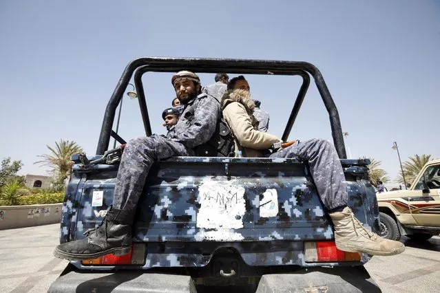 Pro-Houthi soldiers riding a truck patrol during the funeral procession of slain Houthi fighters a day after a Yemen peace initiative was offered by Saudi Arabia, in Sana'a, Yemen, 23 March 2021. Saudi Arabia has offered a peace initiative to the Houthis in Yemen, including a ceasefire and the reopening of Sana'a airport. A Saudi-led coalition has been fighting the Houthis since March 2015. (Photo by Yahya Arhab/EPA/EFE)