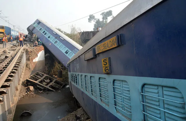 Rescuers and railway officials stand next to derailed coaches of a passenger train near Kanpur in the northern state of Uttar Pradesh, India, December 28, 2016. (Photo by Reuters/Stringer)