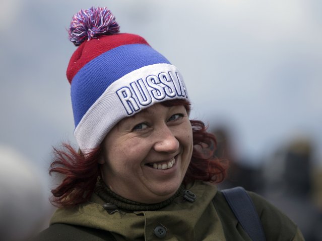 A woman smiles during celebrations for the first anniversary of the Crimean treaty signing in Sevastopol, March 18, 2015. (Photo by Maxim Shemetov/Reuters)