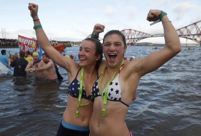 Swimmers participate in the New Year's Day Loony Dook swim at South Queensferry in Scotland, Britain, January 1, 2017. (Photo by Russell Cheyne/Reuters)