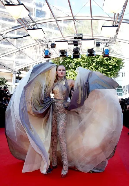 A guest arrives for the screening of the film “De Son Vivant” (Peaceful) at the 74th edition of the Cannes Film Festival in Cannes, southern France, on July 10, 2021. (Photo by Gonzalo Fuentes/Reuters)