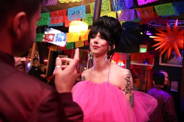 Local San Francisco drag queen performer Curveball talks with a patron during the GAYPEC event hosted at Beaux Night Club in the Castro District of San Francisco, California, U.S., November 15, 2023. (Photo by Brittany Hosea-Small/Reuters)