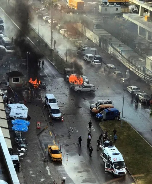 Cars burn after a car bomb explosion in Izmir, Turkey, Thursday, January 5, 2017. An explosion believed to have been caused by a car bomb in front of a courthouse in the western Turkish city of Izmir on Thursday wounded several people, a local official said. Two of the suspected attackers were killed in an ensuing shootout with police. (Photo by DHA-Depo Photos via AP Photo)