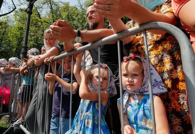 Ukrainian Orthodox believers attend a prayer service held at the St. Vladimir's Hill in downtown Kiev, Ukraine, 27 July 2021. Orthodox believers mark the 1033rd anniversary of the Kievan Rus Christianization on 27 and 28 July 2021. (Photo by Sergey Dolzhenko/EPA/EFE)