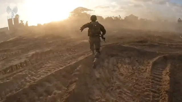 A screengrab taken from a handout video shows what the Israeli army says are its soldiers operating in a location given as the Gaza Strip, released on November 14, 2023. (Photo by Israeli Army/Handout via Reuters)