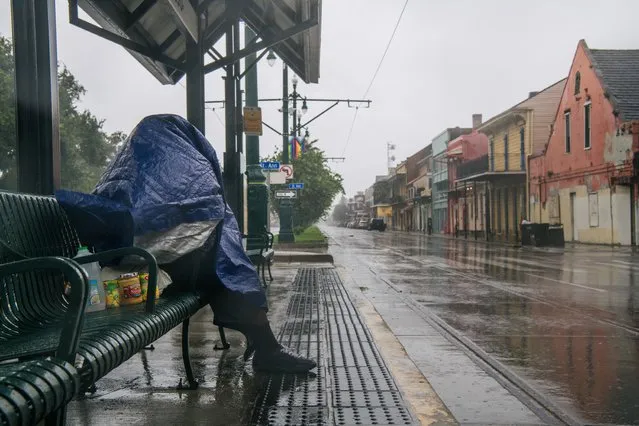 A person sits at a train stop for shelter ahead of Hurricane Ida on August 29, 2021 in New Orleans, Louisiana. Residents of New Orleans continue to prepare as the outer bands of the hurricane begin to cut across the city. Ida is expected to make landfall as a Category 4 storm later today. (Photo by Brandon Bell/Getty Images)