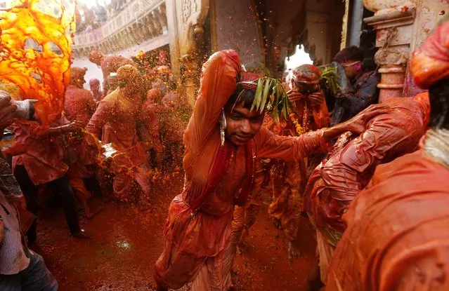 Hindu devotees take part in the religious festival of Holi inside a temple in Nandgaon village, in the state of Uttar Pradesh, India, March 16, 2019. (Photo by Adnan Abidi/Reuters)