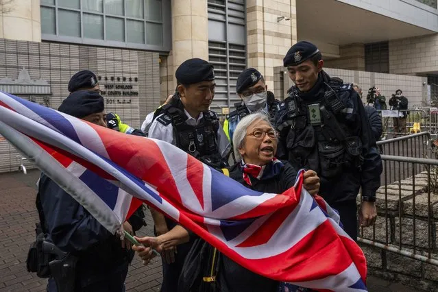 Activist known as “Grandma Wong” is surrounded by police outside court on the verdict day of a trial involving protesters who stormed the Legislative Council during the pro-democracy protests in 2019, in Hong Kong, Thursday, February 1, 2024. (Photo by Louise Delmotte/AP Photo)