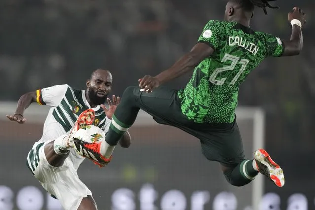 Nigeria's Calvin Bassey, right, challenges Cameroon's Moumi Ngamaleu during the African Cup of Nations Round of 16 soccer match between Nigeria and Cameroon, at the Felix Houphouet Boigny stadium in Abidjan, Ivory Coast, Saturday, January 27, 2024. 2024. (Photo by Sunday Alamba/AP Photo)