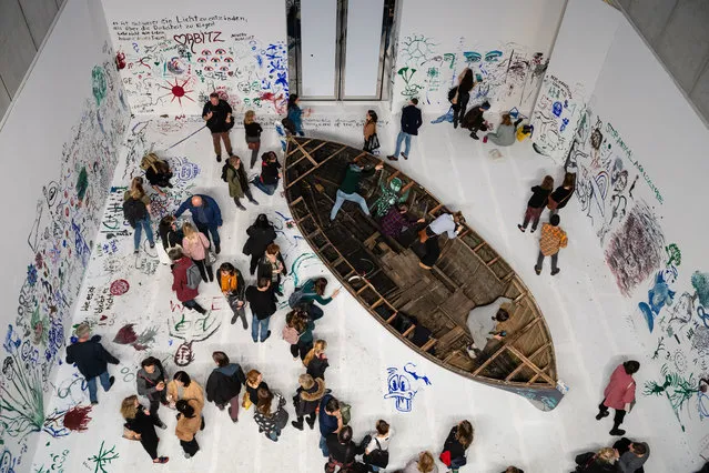 Visitors at the work “Add colour painting (Refugee boat)” of the Japanese-American artist Yoko Ono during the opening of the exhibition “PEACE is POWER” in the Museum of the Fine Arts (Museum der bildenden Kuenste) in Leipzig, Germany, 03 April 2019. Yoko Ono presents her most extensive exhibition of works in Leipzig since her retrospective in the Schirn Kunsthalle in Frankfurt five years ago. (Photo by Jens Schlüter/EPA/EFE)
