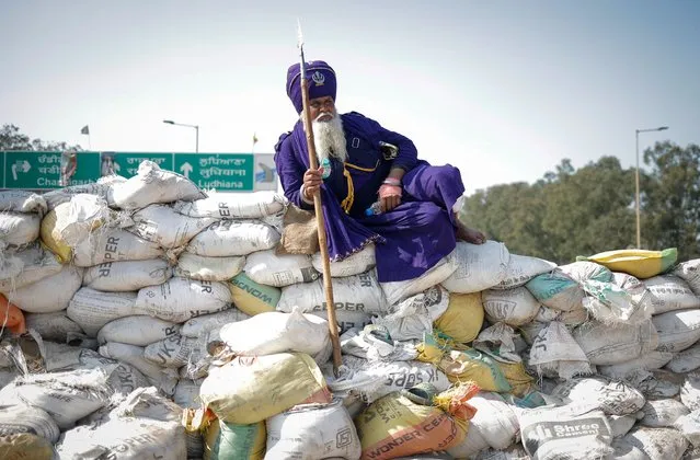 A Nihang or a Sikh warrior rests on a makeshift barricade of sand bags, at a protest site during the march towards New Delhi to push for better crop prices promised to them in 2021, at Shambhu Barrier, the border between Punjab and Haryana states, India on February 23, 2024. (Photo by Adnan Abidi/Reuters)