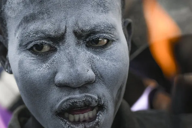 A person believed to be possessed with the spirit of Gede attends a ceremony honoring the Vodou spirit of Baron Samedi and Gede at the National Cemetery in Port-au-Prince, Haiti, Monday, November 1, 2021. (Photo by Matias Delacroix/AP Photo)