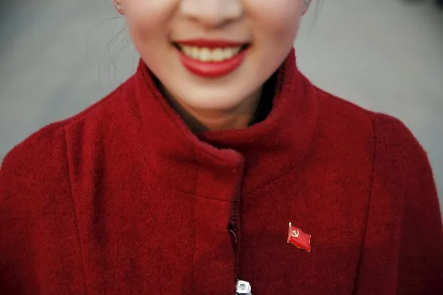 A hostess wears a pin of China's Communist Party flag ahead of the closing ceremony of National People's Congress (NPC) at the Great Hall of the People in Beijing, China, March 16, 2016. (Photo by Damir Sagolj/Reuters)