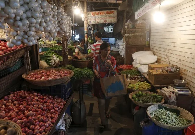 A woman shops at a vegetable market in a residential area in Mumbai, India, March 22, 2016. (Photo by Shailesh Andrade/Reuters)