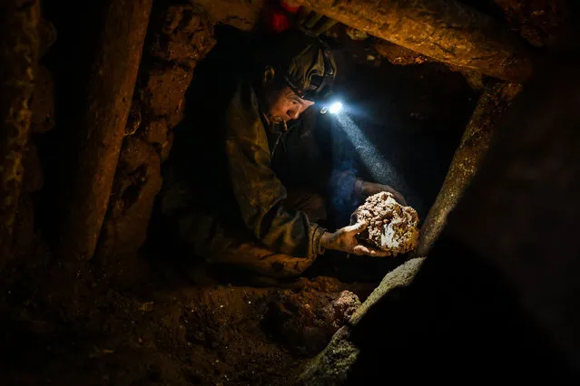 This photo taken on May 16, 2019 shows a miner working in a tunnel in a ruby mine in Mogok, north of Mandalay. (Photo by Ye Aung Thu/AFP Photo)