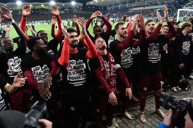 Kaiserslautern's players celebrate their team's 2-0 win with fans after the German Cup (DFB Pokal) semi-final football match between 1 FC Saarbruecken and 1 FC Kaiserslautern at the Ludwigsparkstadion in Saarbruecken, western Germany on April 2, 2024. (Photo by Jean-Christophe Verhaegen/AFP Photo)