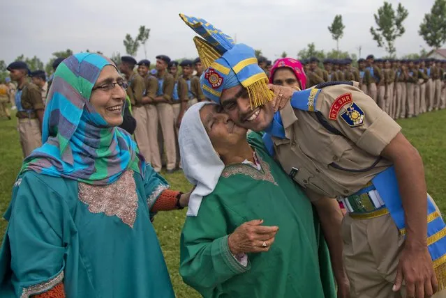 A woman kisses the forehead of her grandson after he was inducted as a soldier of the Indian Central Reserve Police Force (CRPF) at a base camp on the outskirts of Srinagar, Indian controlled Kashmir, Thursday, May 14, 2015. More than three hundred new CRPF soldiers will join the Indian security men fighting separatist Islamic guerrillas in Kashmir and Maoist rebels in different parts of India. (Photo by Dar Yasin/AP Photo)