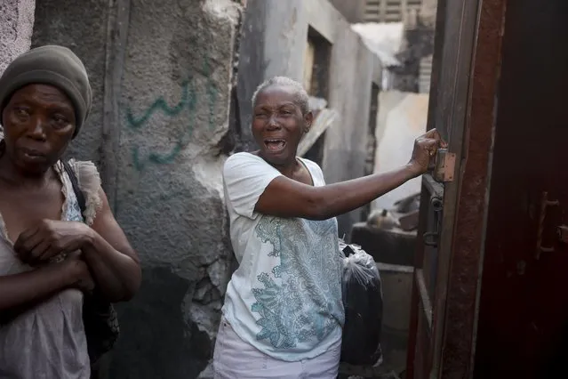 Nelly Joseph stands in her damaged home in Cap-Haitien, Haiti, Wednesday, December 15, 2021. Joseph said her son and granddaughter died in the house when a gasoline truck overturned and exploded, killing dozens of residents. (Photo by Joseph Odelyn/AP Photo)