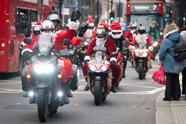 Motorcyclists dressed as Father Christmas driving along Oxford Street, London on Thursday, December 23, 2021 as the government refused to rule out introducing further restrictions to slow the spread of the Omicron variant of coronavirus. (Photo by Stefan Rousseau/PA Images via Getty Images)