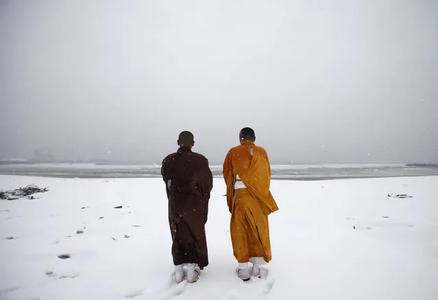 Buddhist monks offer prayers for victims at Kitaizumi beach in Minamisoma, Fukushima prefecture, March 10, 2012. (Photo by Yuriko Nakao/Reuters)