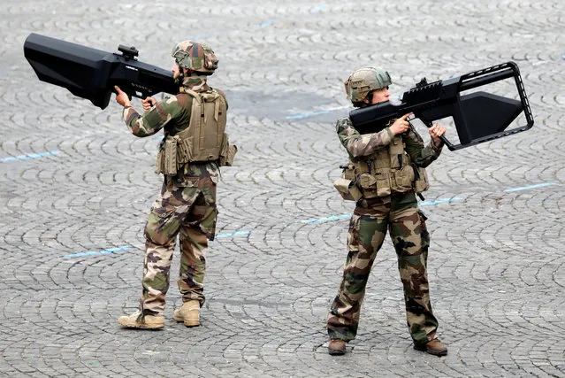 French Army soldiers hold anti-drone guns during the traditional Bastille Day military parade on the Champs-Elysees Avenue in Paris, France, July 14, 2019. (Photo by Charles Platiau/Reuters)