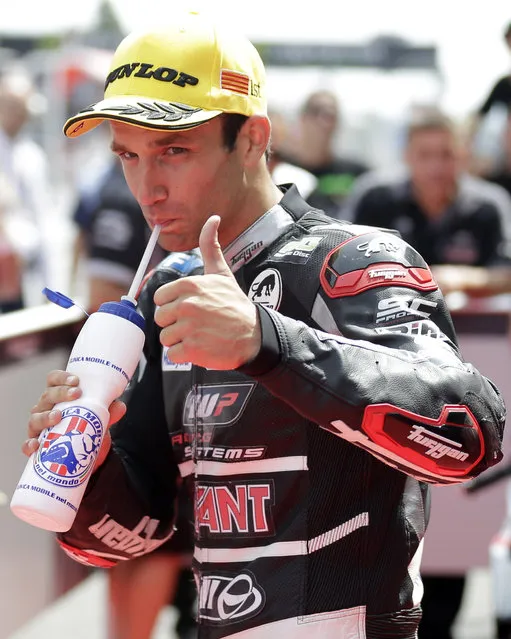 Moto2 rider Johann Zarco of France gestures after clocking the fastest time to take pole position for Sunday's Spanish Motorcycling near of second fastest time Spain's Maverick Vinales, center right, in Montmelo, Spain, Saturday, June 13, 2015. The Catalunya Grand Prix will take place on Sunday in Montmelo. (AP Photo/Manu Fernandez)