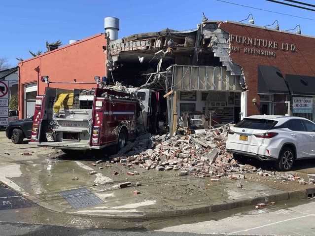 A firetruck sits amid rubble after crashing into a furniture store, Friday, March 1, 2024, in Rockville, Center. A store employee and three firefighters inside the truck were hospitalized with non-life threatening juries, according to a Rockville Center police department spokesperson. (Photo by Ted Phillips/Newsday via AP Photo)