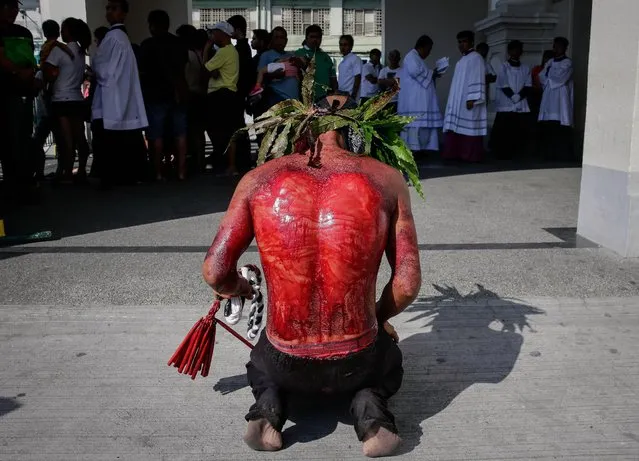 A Filipino flagellant whips his back in front of a church on Maundy Thursday in San Fernando, Pampanga, north of Manila, Philippines, 13 April 2017. Many Filipino Catholic penitents mark the Holy Week by submitting to different forms of physical penance in the hopes of being forgiven for their sins. (Photo by Mark R. Cristino/EPA)
