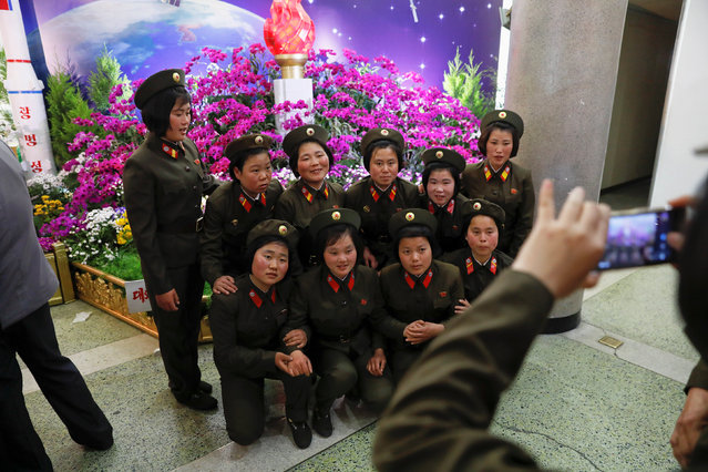 Soldiers pose for a photo during the flower exhibition marking the 105th birth anniversary of the country's founding father, Kim Il Sung in Pyongyang, North Korea April 16, 2017. (Photo by Damir Sagolj/Reuters)